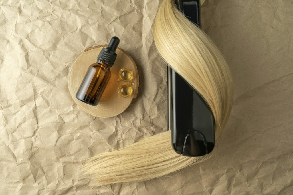 A hair treatment essential oil for smoothing hair and a hair smoothing iron